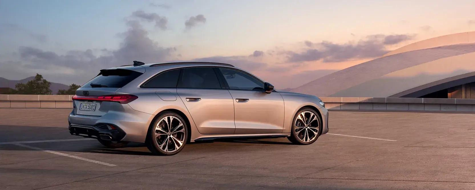 Der neue Audi A5 Avant 1 Grauer Audi A5 Avant von der Seite steht auf einem Hochdeck eines Parkhauses bei Sonnenuntergang
