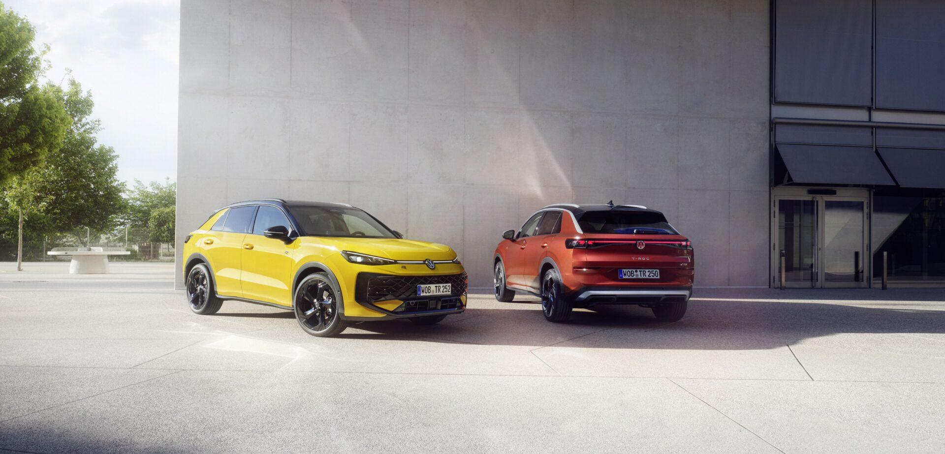Der neue T-Roc 1 Zwei VW T-Roc SUV, ein gelber von vorne links und ein roter von hinten rechts, vor einer modernen Betonfassade mit Glasfassade rechts.